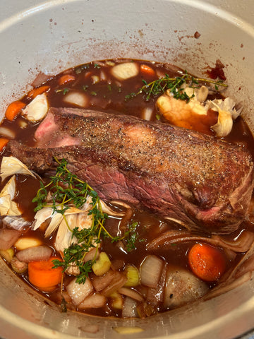 Bison short ribs in a Dutch oven with vegetables