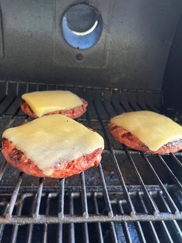 Blended burgers on the grill, topped with cheese