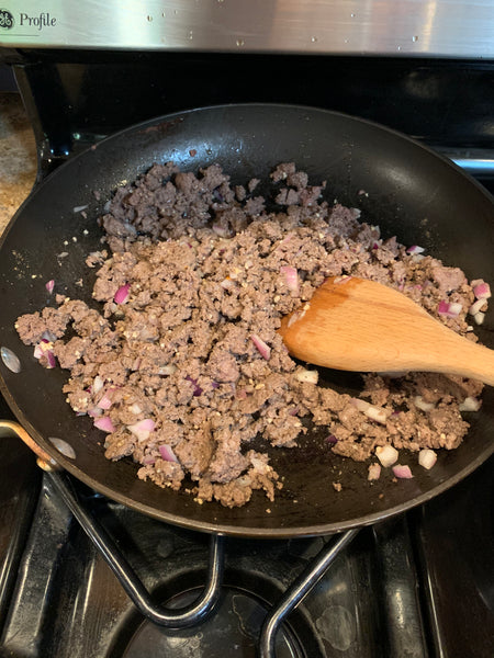 Pan of ground elk meat being cooked