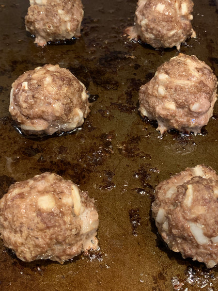 Cooked meatballs on a sheetpan