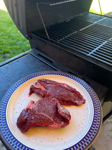 Two elk ribeye steaks ready for the grill