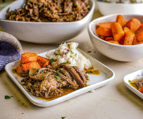 Meat, carrots and potatoes on plates