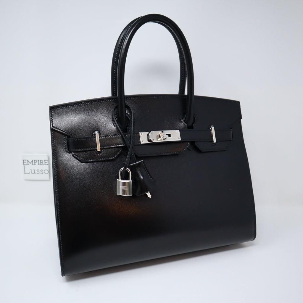 HERMÈS, BLACK RETOURNE KELLY 32CM OF CLEMENCE LEATHER WITH GOLD HARDWARE, Handbags & Accessories, 2020