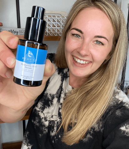 Image of a woman holding up a paraben free BBE serum.