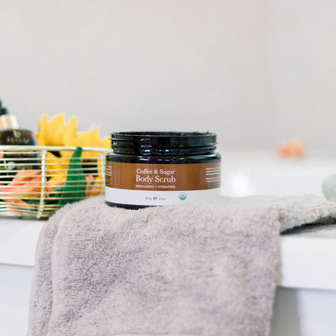 Image of the BBE Coffee & Sugar Body scrub on top of a towel.