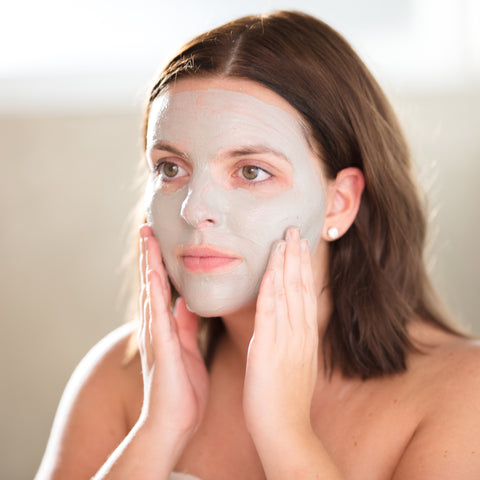 Woman applying beauty by earth hydrating face mask