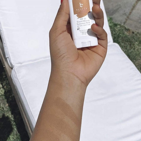 Image of a hand holding the BBE tinted mineral sunscreen stick, a back to school essential.