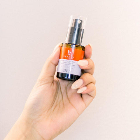 Image of a hand holding BBE's new Vitamin C serum.