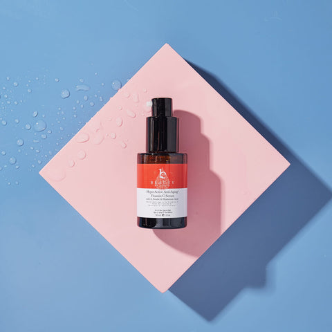 Vitamin c serum on a pink and blue background