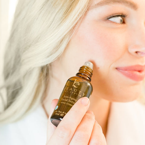 Image of a woman applying BBE's anti-aging serum to her cheek.