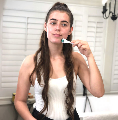 Woman using bbe derma roller as part of her skincare routine