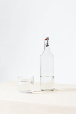 Glass water bottle on a white background