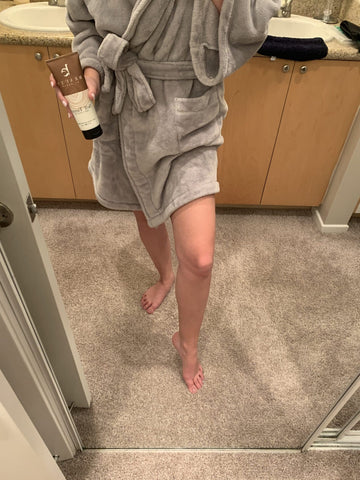 Image of a BBE customer in a comfy robe using her self-tanner.