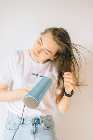Woman blow drying her hair