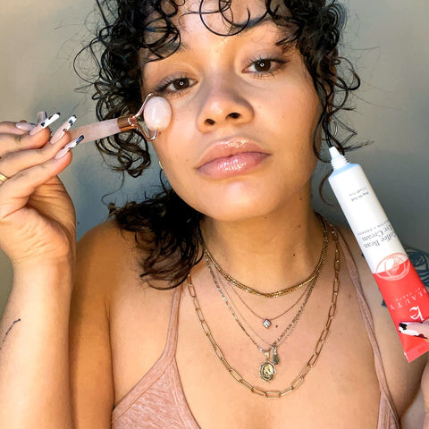 girl using rose roller and eye cream