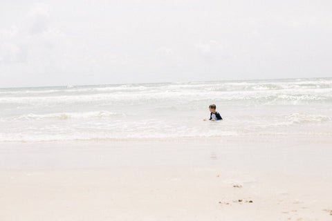 kid sitting in the ocean