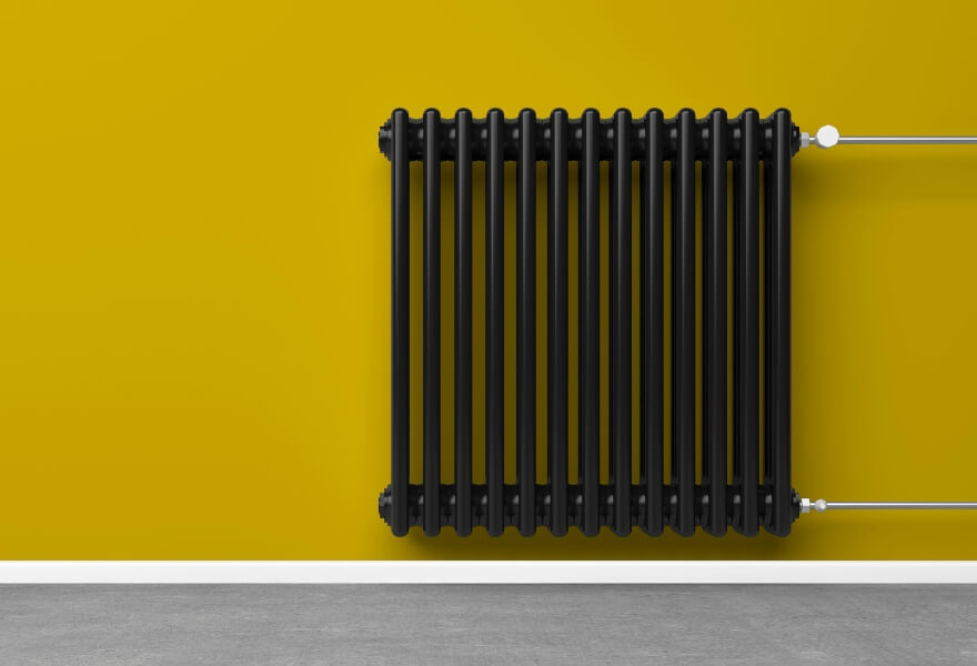 how-to-make-radiators-work-with-your-home-yellow-painted-wall-black-radiator