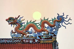 Moon over traditional Chinese dragon roof decoration