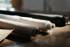 Fabric rolls on wooden cutting table