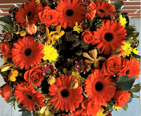 Funeral flower wreath with orange flowers