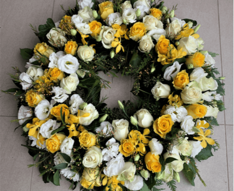 Large white and yellow flowers funeral wreath.