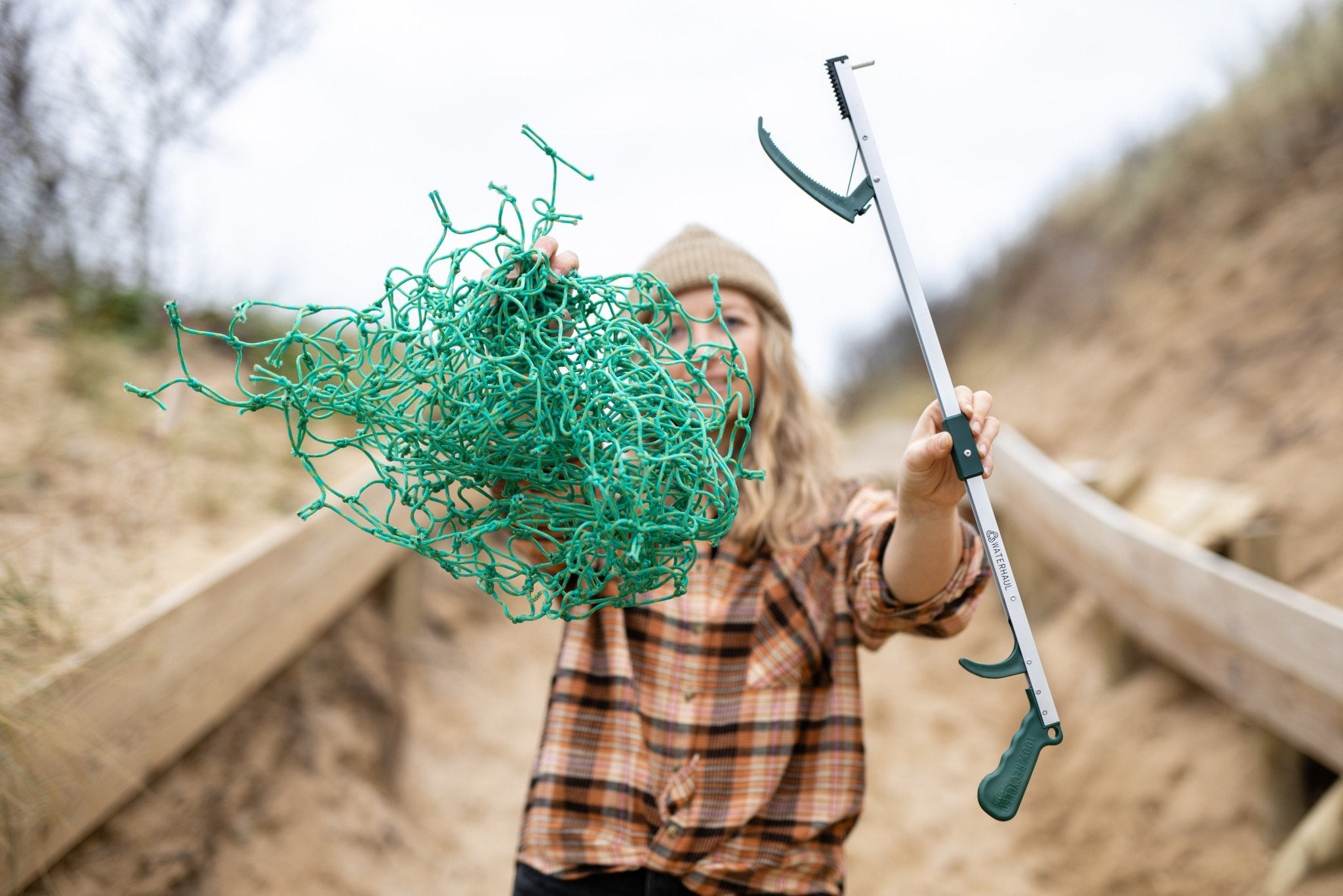 Litter picker being used on beach clean collecting ghost gear