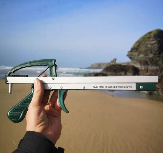 Folding litter picker made from recycled plastic on beach