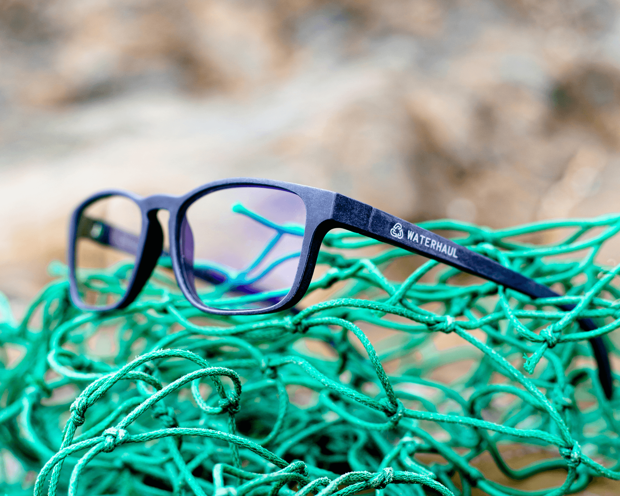 waterhaul blue light blocking glasses on pile of green fishing net