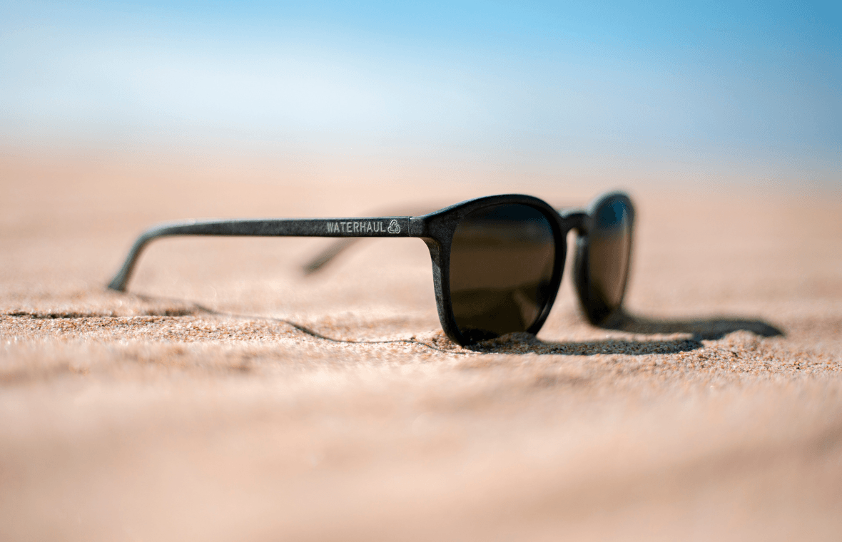 black waterhaul sunglasses on sandy beach