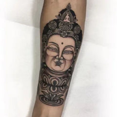 tatouage tête de bouddha avant bras