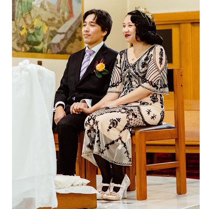 Carolyn and her husband sit together during their ceremony