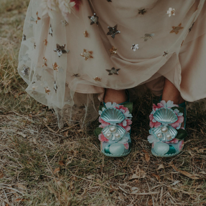 A closeup of Keeley's blue mermaid shoes, with shells on the toe