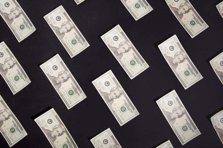 New app ideas: rows of american bills against a black background