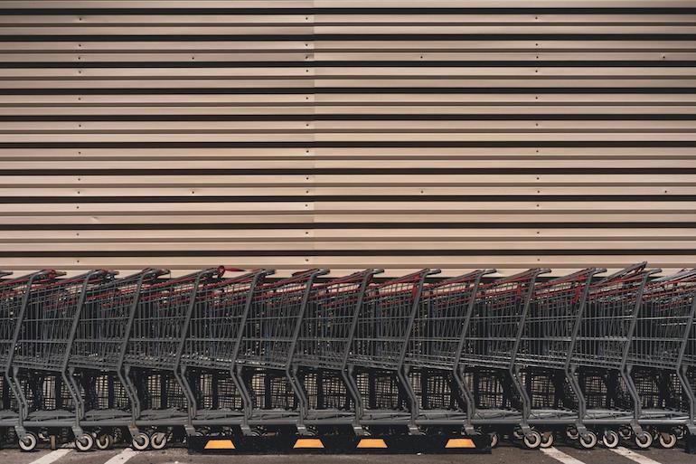 Shopify app challenge: row of shopping carts against brown wall