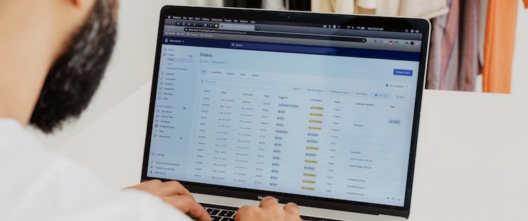 app development business trends: man working on computer in the shopify CMS
