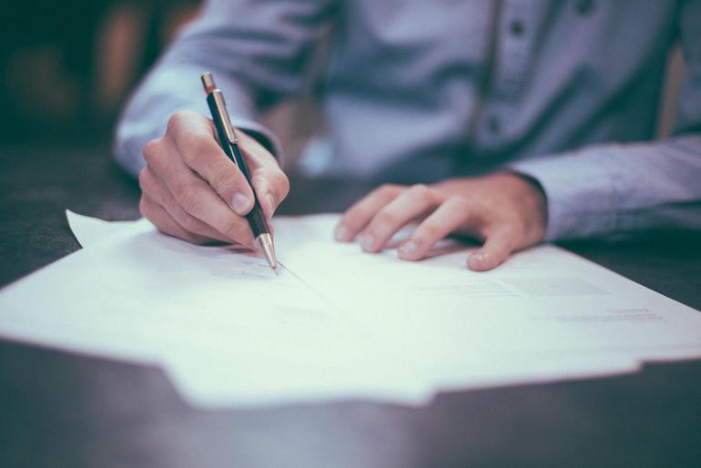 business cash flow: person writing on a table