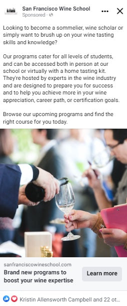 Screenshot of a social media ad for San Francisco Wine School with a text description of the school's programs with a photo of a sommelier pouring a white wine into a wine taster's glass. Below is a call-to-action button for the reader to learn more.