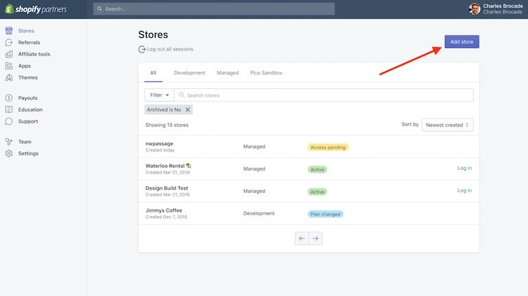 Development stores: Screenshot of the Stores page within the Partner Dashboard, showing four development stores and an arrow pointing to the button in the top right corner that says Add store.