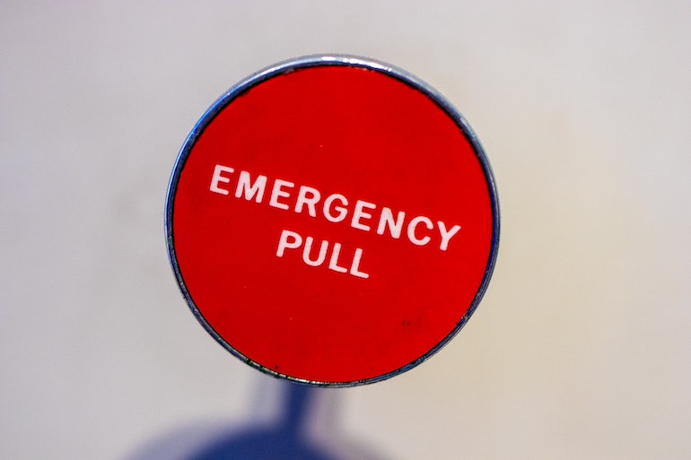 Large red circle with the words "Emergency Pull" in the middle