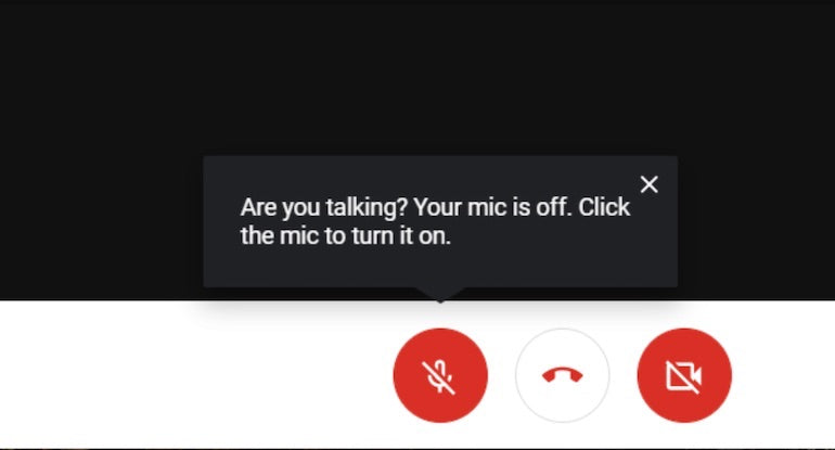 microcopy: Screenshot of a google meet displaying the "mute" "talk" and "hangup" buttons, with a text box that indicated the mic is picking up a speaker and suggests the speaker unmute themselves