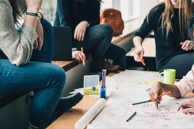 theme store success: An image of a team of four people working on design sketches and notes.