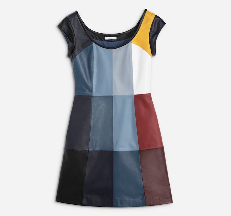  Leather dress with thin, rounded black collar in front and back, short black sleeves. Dress pattern is made up of colored and symmetrical vertical rectangles. Colors include mostly various shades of blue with a small amount of yellow, white, red, maroon and grey. Waist tapers inward.