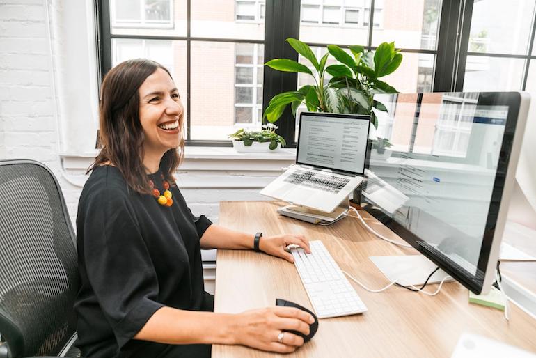 virtual events: woman sitting at desk smiling