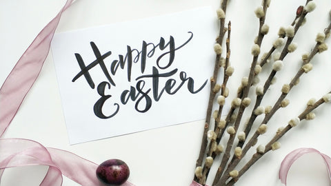 Happy Easter hand lettered sign with pussy willow and a painted egg.