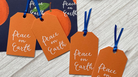 Matching orange Christian peace on earth gift tags and Christmas wrapping paper