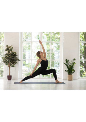 Woman executing warrior two variation yoga pose.