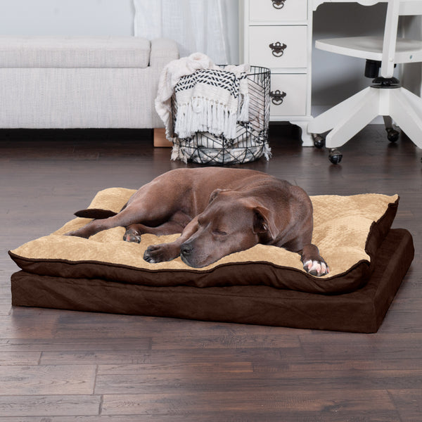 A dark brown dog lying on a FurHaven Deluxe Mattress Dog Bed on deep brown hardwood floor