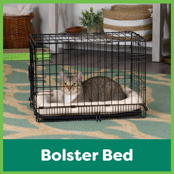 A cat sleeps in a cream colored FurHaven bolstered crate mat for cats and dogs.