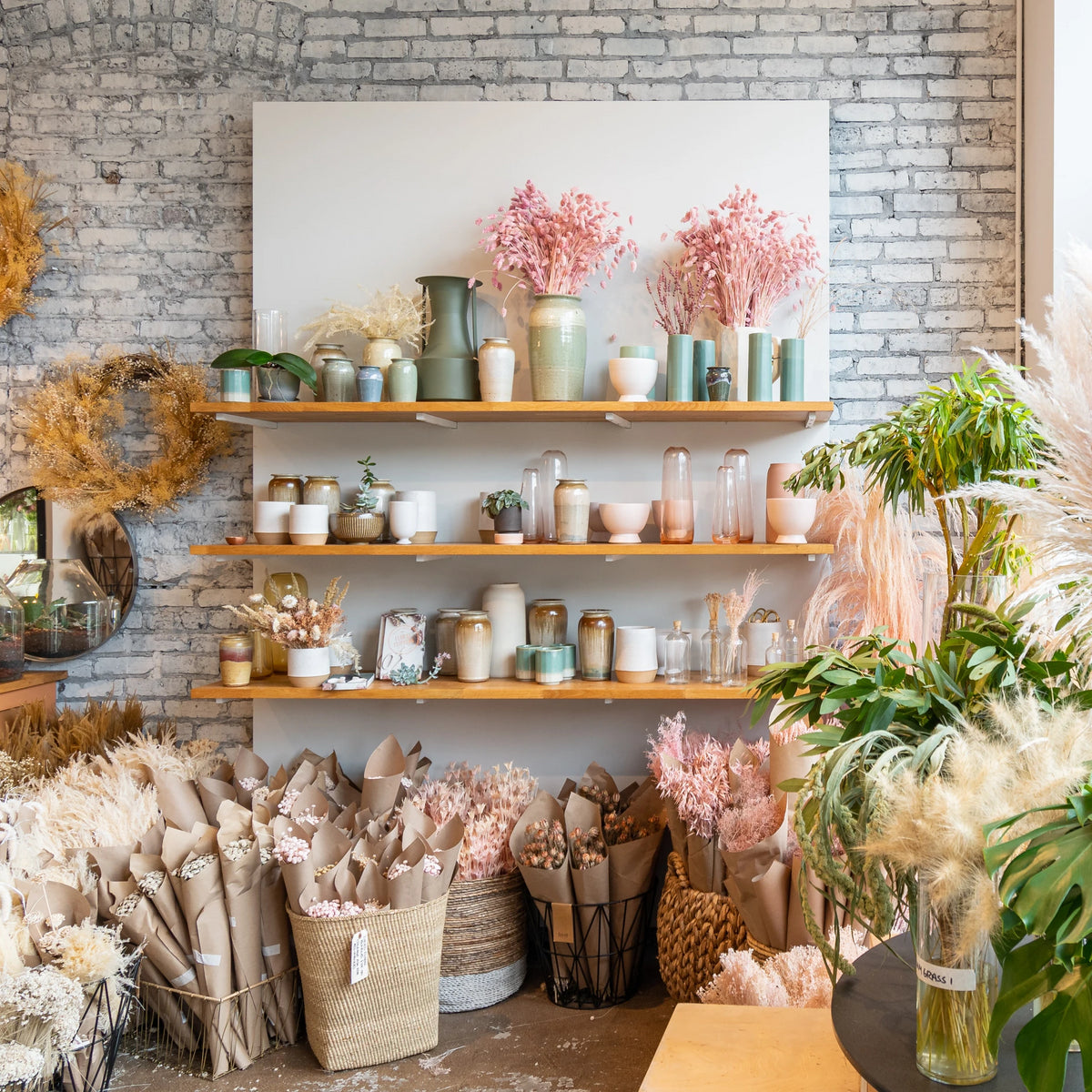 Photo of display shelves and dried floral bundles at Sprout Home's floral store