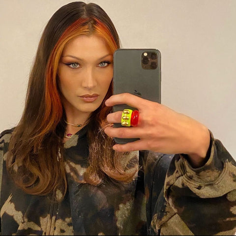 Aesthetic photo of girl with money piece hair coloring technique clicking a selfie in the mirror